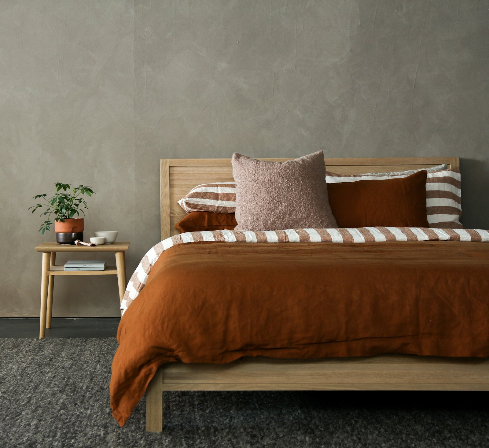 Garden Room — a warm bedroom with terracotta linen and an oak bed frame